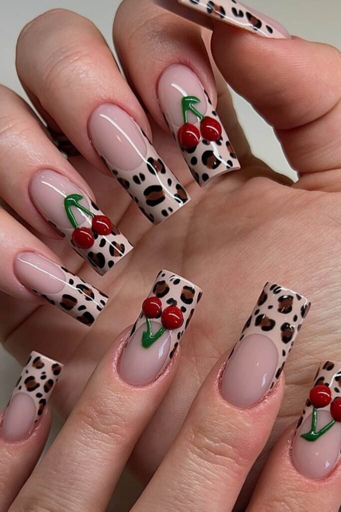 Fierce, bold, and full of Leo energy, this French manicure takes cherry nails to the next level. With a leopard skin tips accents, and red cherry on a nude background, this design is made for those who love to stand out. Perfect for a birthday manicure or anyone who loves astrology-themed nails!