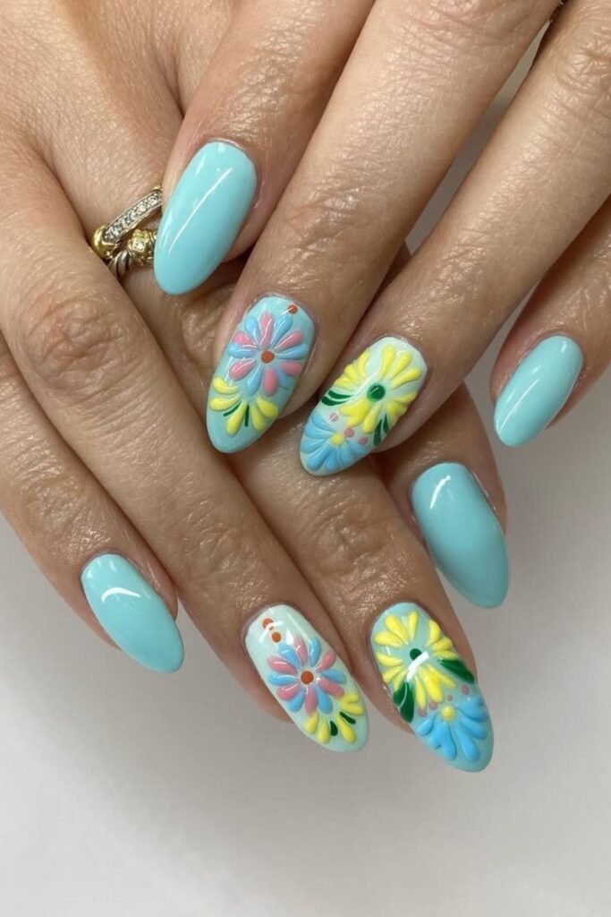 These nails exude the perfect combination of simplicity and fun. Each nail features tiny, colorful floral designs that reflect traditional Mexican nail designs.