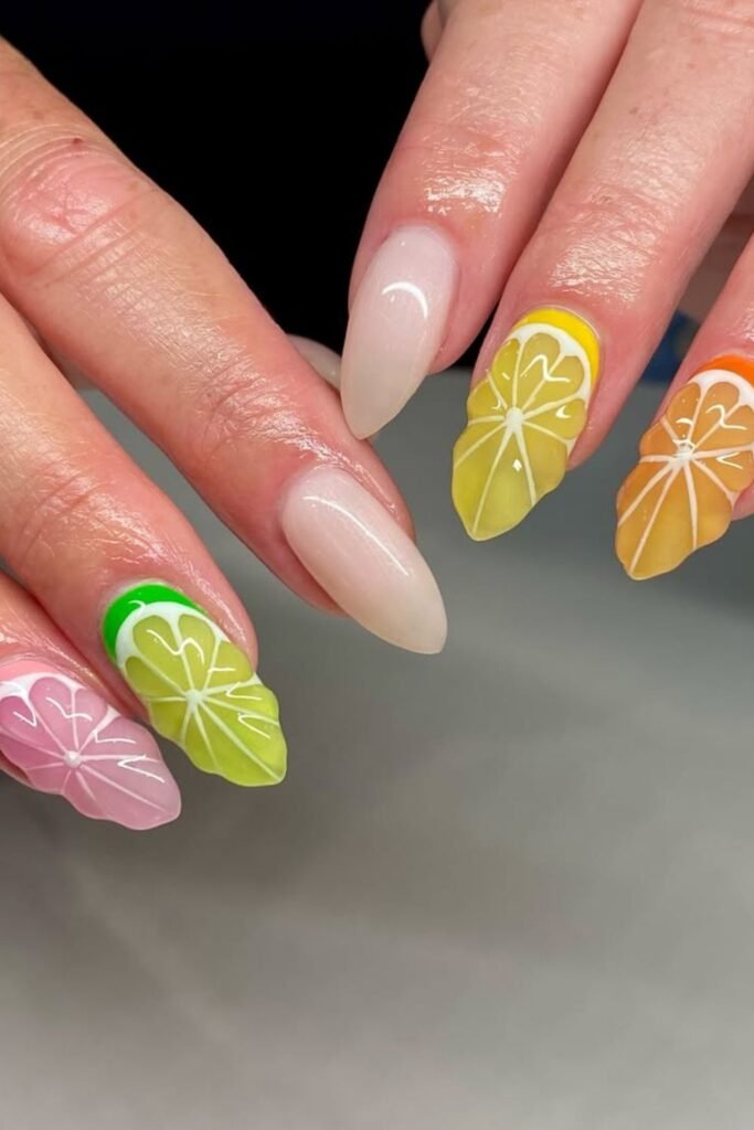 These nails combine warm tones like pink, green, yellow, and orange, each beautifully blended into a soft gradient. The detailed white citrus slice designs add a juicy touch to these Cinco de Mayo nails designs.