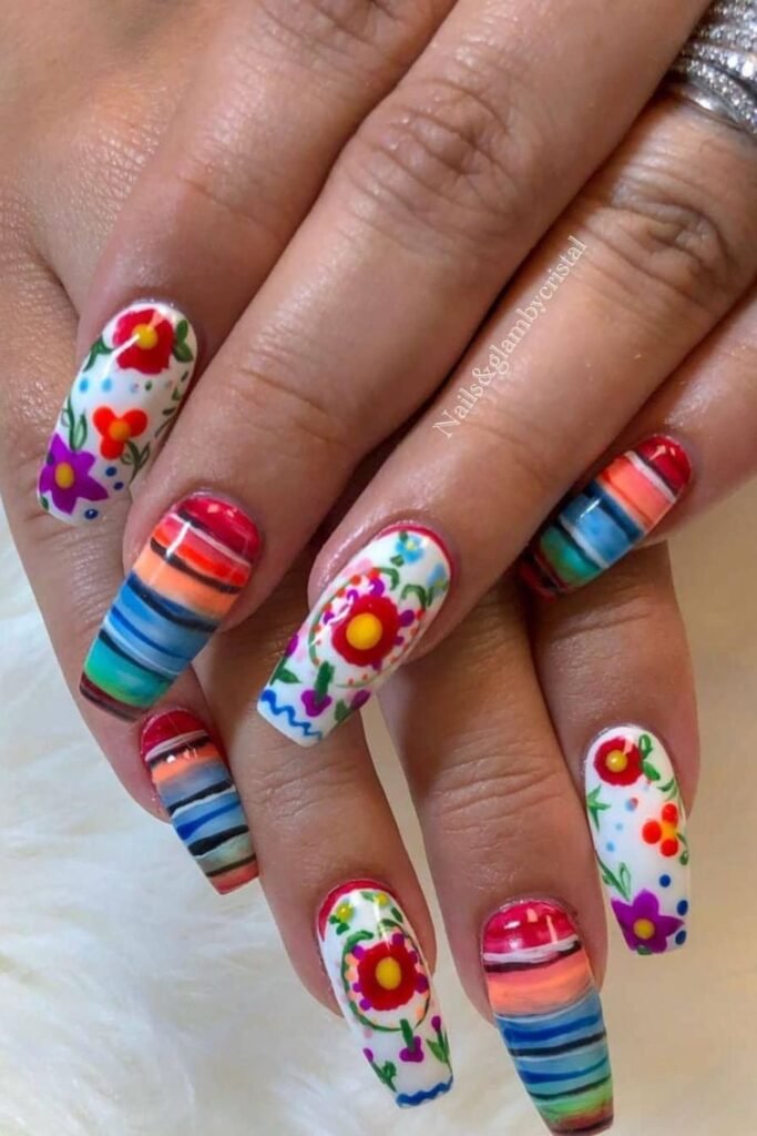 Celebrate Cinco de Mayo in Round Rock with stunning long nails featuring intricate Mexican-inspired designs. Beautiful flowers, bold stripes, and abstract patterns come together to create festive, eye-catching nail art perfect for the holiday.