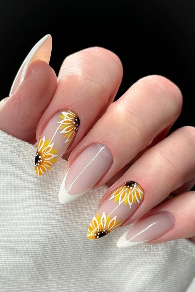 Looking for a fresh twist on French tips? These sunflower nails are a stunning blend of classic sophistication and bold floral charm. The delicate sunflower nail art sits gracefully atop crisp white tips, creating a timeless yet playful look.