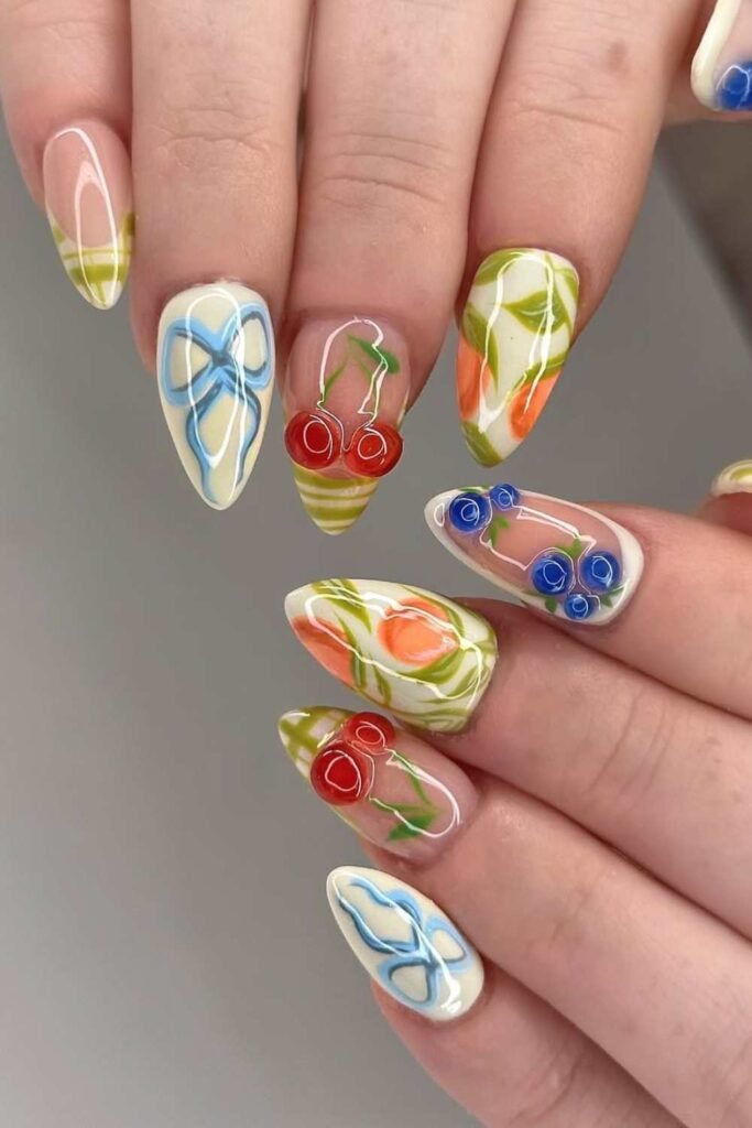 Almond-shaped pastel nails with 3D strawberries, florals, and bows—perfect for a fun, flirty spring break vibe.
