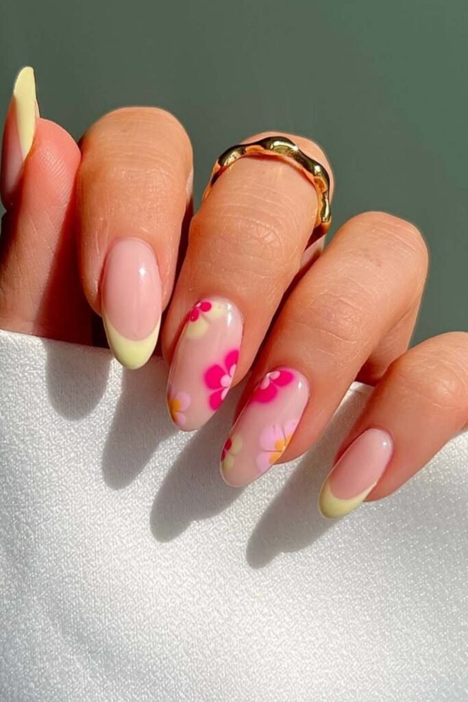 Floral French tips with yellow edges on short nails.