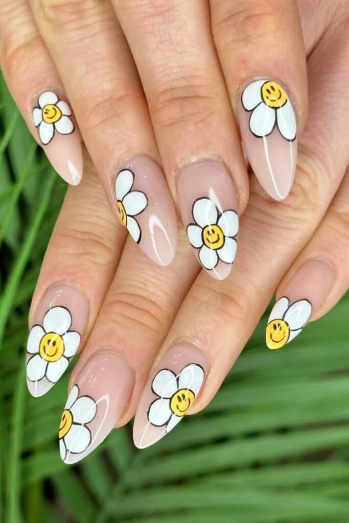 Nude nails with daisy flower designs.