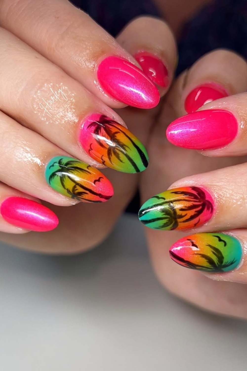 Sunset gradient nails with black palm tree silhouettes.