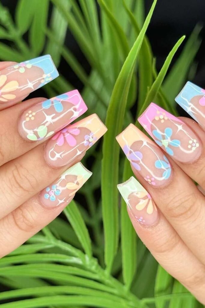 Pastel French tip nails with daisy designs.