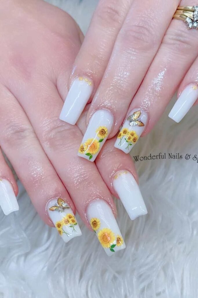 White nails with sunflower art.