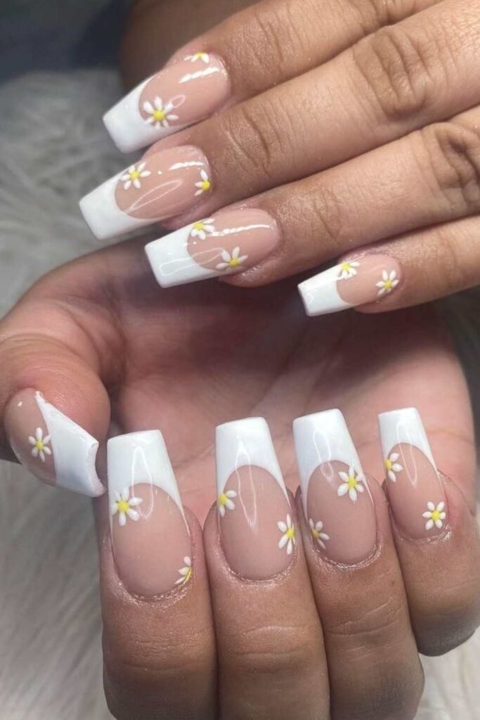 French tip nails with yellow and white floral accents